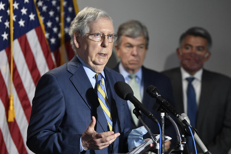 Senate Majority Leader Mitch McConnell of Ky., left, speaks to reporters following the weekly Republican policy luncheon on Capitol Hill in Washington, Tuesday, June 9, 2020. Sen. Roy Blunt, R-Mo., center, and Sen. Cory Gardner, R-Colo., right, listen. (AP Photo/Susan Walsh)