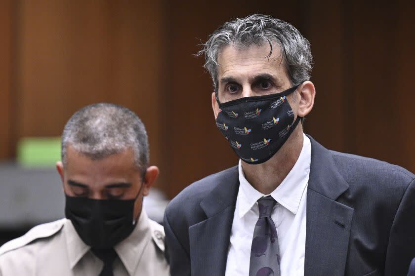 Hollywood television producer Eric Weinberg, right, looks up after bail was denied at his arraignment on Tuesday, Oct. 25, 2022, in Superior Court in Los Angeles. Weinberg, executive producer for the hit TV show "Scrubs," was denied bail after pleading not guilty to sexually assaulting five women who prosecutors said he lured to photo shoots. (Robyn Beck/Pool Photo via AP)