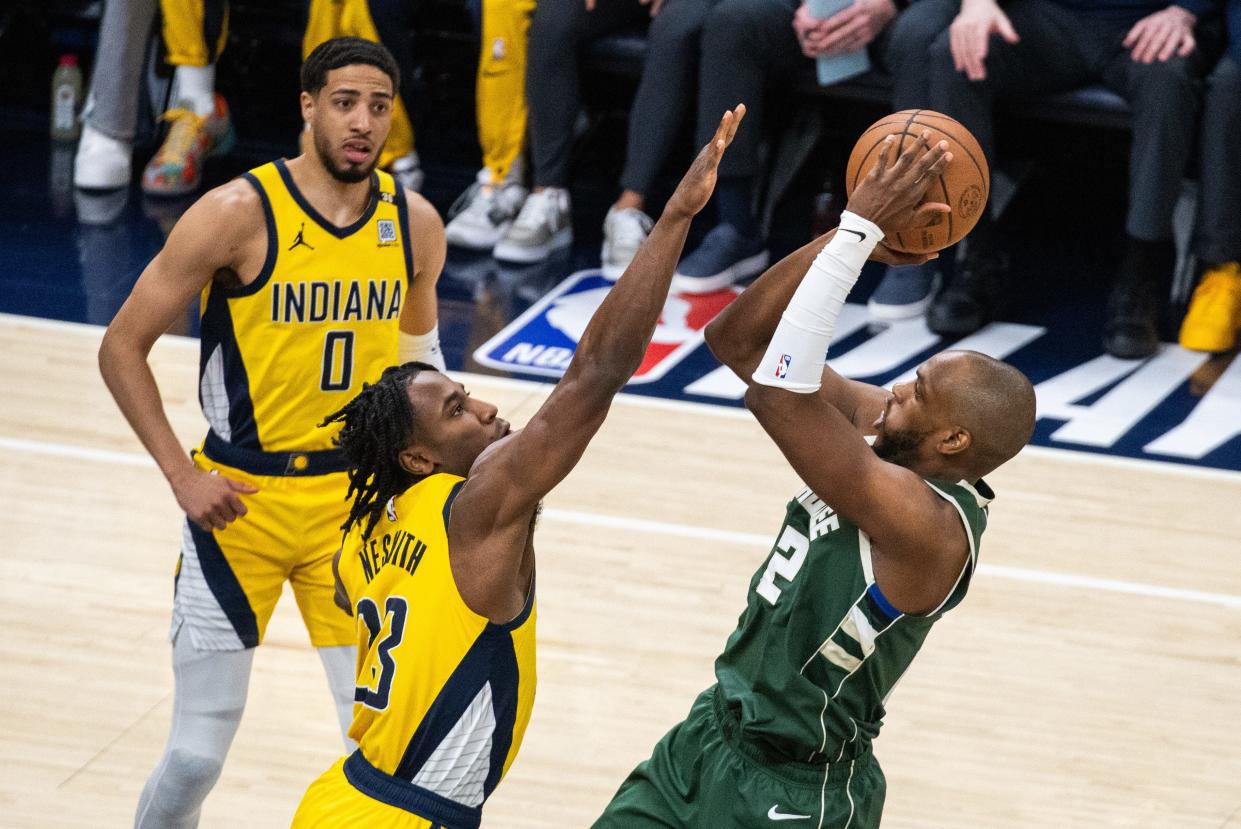 May 2, 2024; Indianapolis, Indiana, USA; Milwaukee Bucks forward Khris Middleton (22) shoots the ball while Indiana Pacers forward Aaron Nesmith (23) defends during game six of the first round for the 2024 NBA playoffs at Gainbridge Fieldhouse. Mandatory Credit: Trevor Ruszkowski-USA TODAY Sports