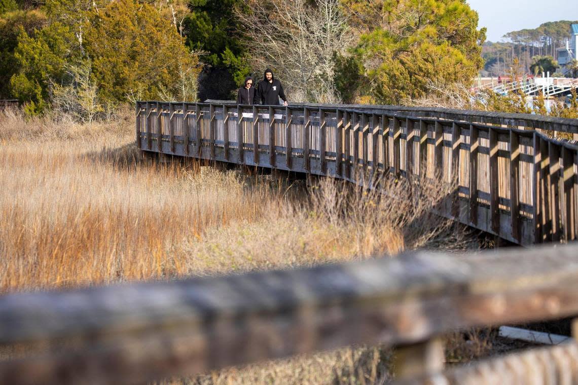 Visitors to the Heritage Shores Nature Preserve walk one of the elevated boardwalks over the marsh at Hog Inlet in North Myrtle Beach. The Myrtle Beach area still has some undisturbed natural places to go for a nature hike. January 11, 2023.