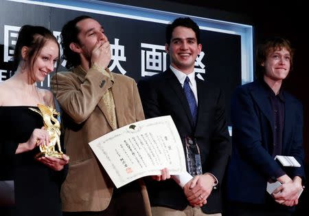 Director Josh Safdie (R) reacts next to his brother Benny Safdie as they receive the Tokyo Grand Prix for the film "Heaven Knows What ", which they directed together, during the closing ceremony of the Tokyo International Film Festival in Tokyo October 31, 2014. REUTERS/Yuya Shino