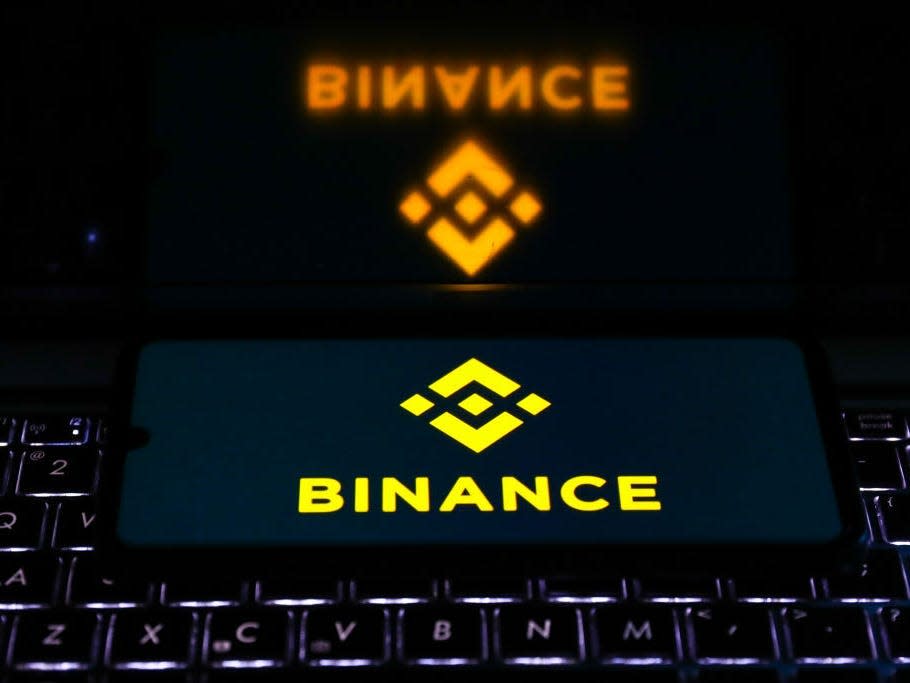 Binance logo is displayed on a mobile phone screen