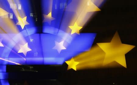 The famous euro sign landmark is photographed outside the former headquarters of the European Central Bank (ECB) in Frankfurt, late evening January 20, 2015. The ECB governing council will meet on Thursday, January 22. REUTERS/Kai Pfaffenbach/Files