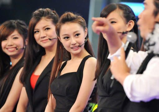 Chinese native Qi Ji (C) and her Taiwanese teammates answer questions after performing during a new talent show "Asian Idol Group Competition," in Taipei, in May. Growing numbers of young Chinese performers are eschewing the entertainment scene at home and instead coming to Taiwan in the hope of getting a big break