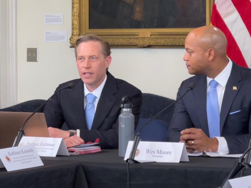 Nathan Hultman, director of the Center for Global Sustainability at the University of Maryland, speaks during a roundtable discussion on the state's climate goals in Annapolis on April 3, 2023. Gov. Wes Moore, at right, looks on.
