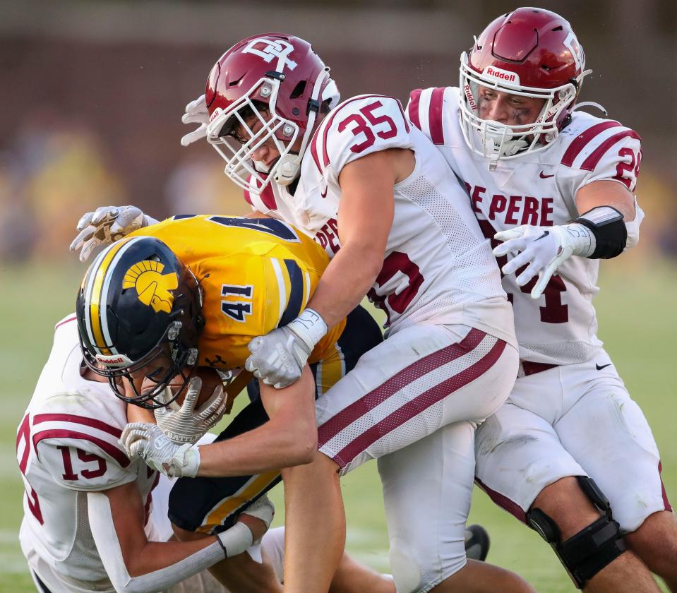 De Pere's Carter Kaufmann (19), Max Cavanaugh (35) and Derrick Bunkelman (24) converge on Wausau West's Ray Reineck (41) during a game in August. Bunkelman has committed to play at Drake next season.