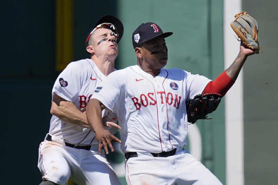 Boston Red Sox's Rafael Devers, right, collides with teammate Tyler O'Neil after making the catch on a pop out by Cleveland Guardians' Estevan Florial during the seventh inning of a baseball game, Monday, April 15, 2024, in Boston. (AP Photo/Michael Dwyer)