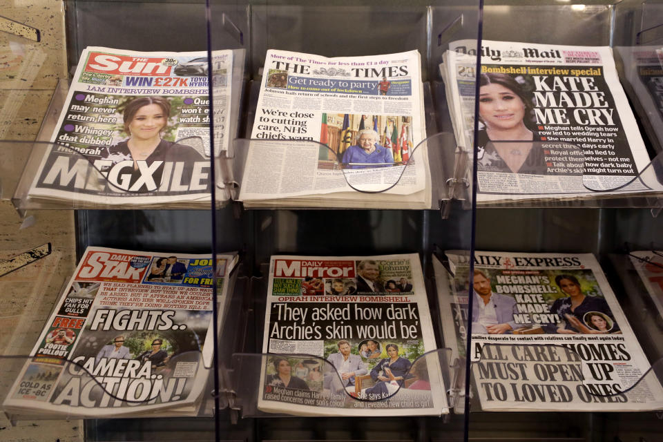 Newspapers are displayed for sale outside a shop in London, Monday, March 8, 2021. Britain's royal family is absorbing the tremors from a sensational television interview by Prince Harry and the Duchess of Sussex, in which the couple said they encountered racist attitudes and a lack of support that drove Meghan to thoughts of suicide. (AP Photo/Kirsty Wigglesworth)