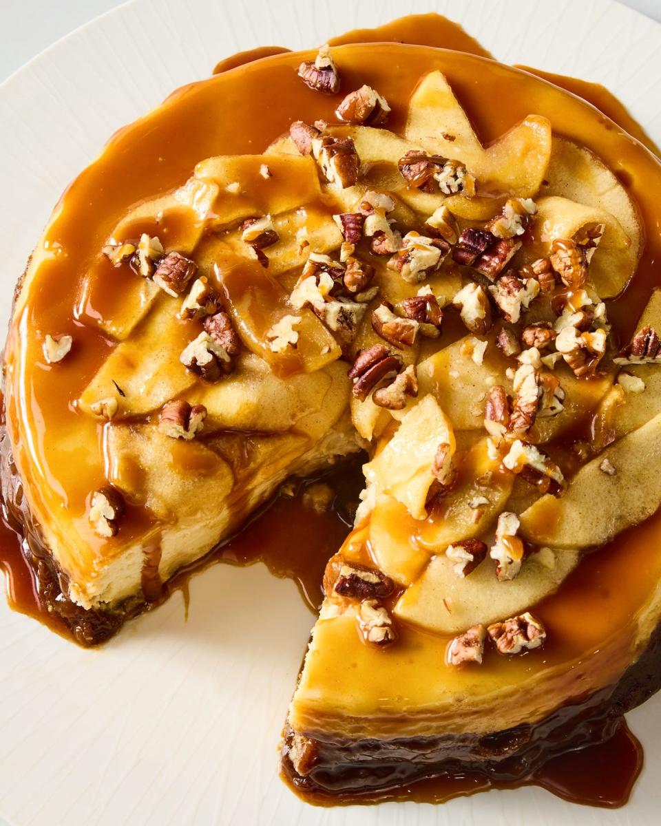 cheesecake with a caramel apple topping and crushed pecans