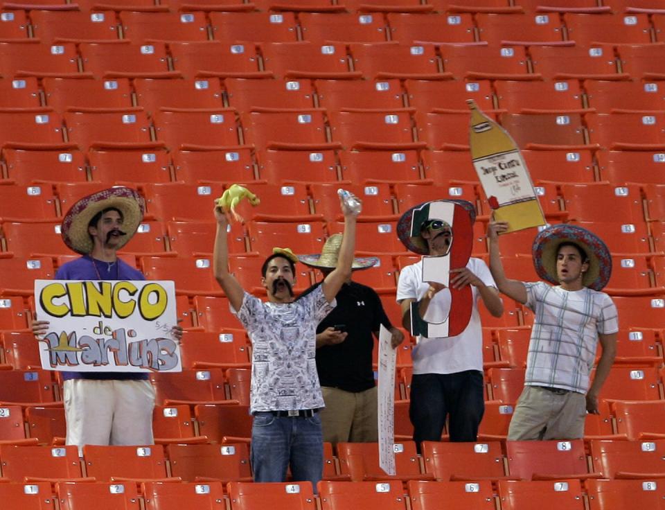 Miami Marlins baseball fans don sombreros and hold up placards to celebrate Cinco de Mayo. <a href="http://www.apimages.com/metadata/Index/Reds-Marlins-Baseball/842f23c285f7488a982b7e0371af29a6/393/0" rel="nofollow noopener" target="_blank" data-ylk="slk:AP Photo/Wilfredo Lee;elm:context_link;itc:0;sec:content-canvas" class="link ">AP Photo/Wilfredo Lee</a>