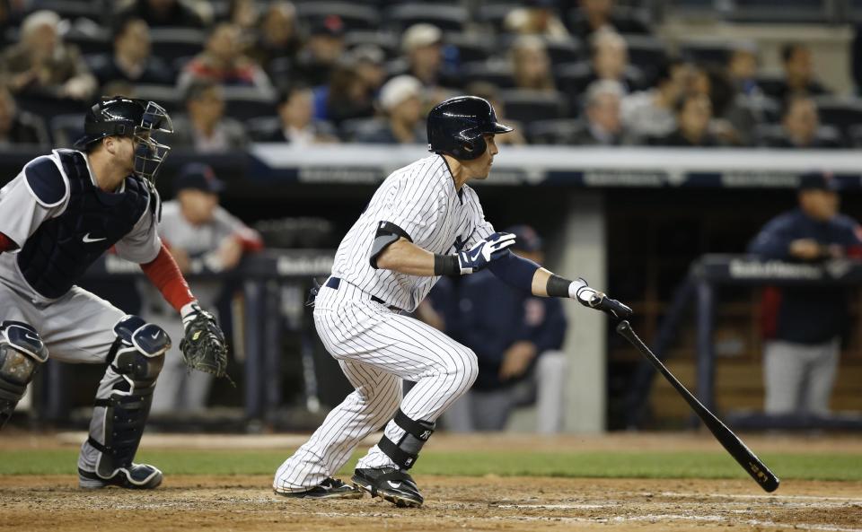 New York Yankees' Jacoby Ellsbury, right, hits a fifth-inning RBI-double in a baseball game against the Boston Red Sox at Yankee Stadium in New York, Thursday, April 10, 2014. (AP Photo/Kathy Willens)