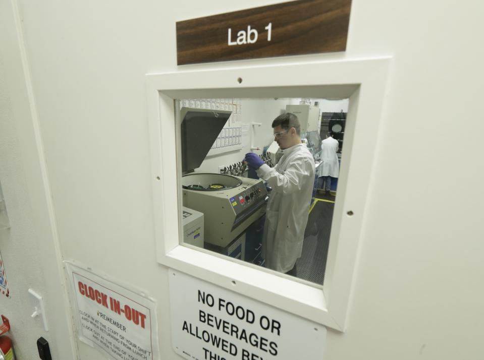 Researchers work at Flora Research Laboratories in Grants Pass, Ore., on July 18, 2019. The Associated Press commissioned the lab to test vape products as part of an investigation that shows a dark side to the booming industry selling the cannabis extract CBD. The lab tested 30 vape products sold around the country as CBD that AP chose by targeting brands that law enforcement authorities or users flagged as suspect. Ten of the 30 samples contained synthetic marijuana, a street drug commonly known as K2 or spice. (AP Photo/Ted Warren)