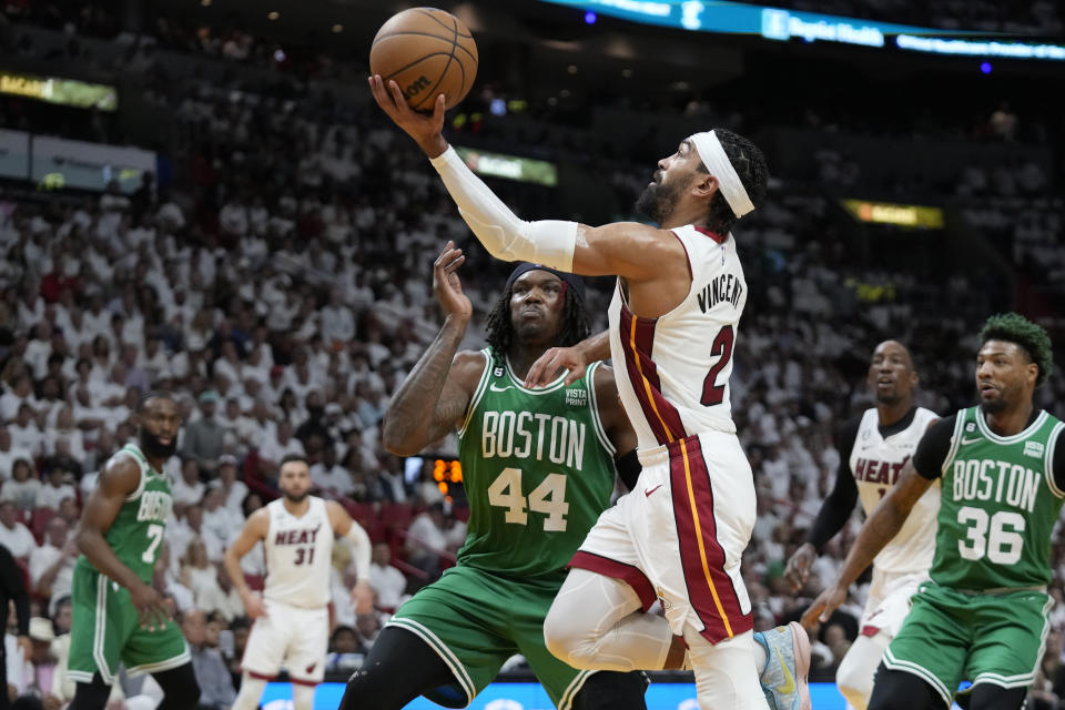 Miami Heat guard Gabe Vincent (2) drives to the basket over Boston Celtics center Robert Williams III (44) during the first half132 of Game 4 during the NBA basketball playoffs Eastern Conference finals, Tuesday, May 23, 2023, in Miami. (AP Photo/Wilfredo Lee)