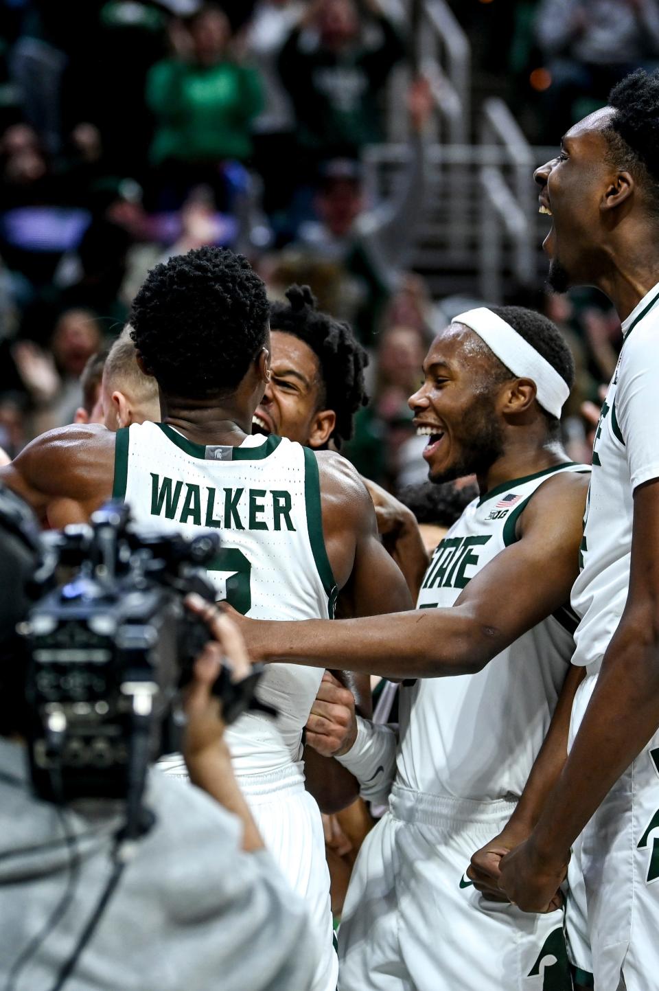 Michigan State's Steven Izzo is swarmed by teammates after making a basket and drawing a foul against Rutgers during the second half on Sunday, Jan. 14, 2024, at the Breslin Center in East Lansing.
