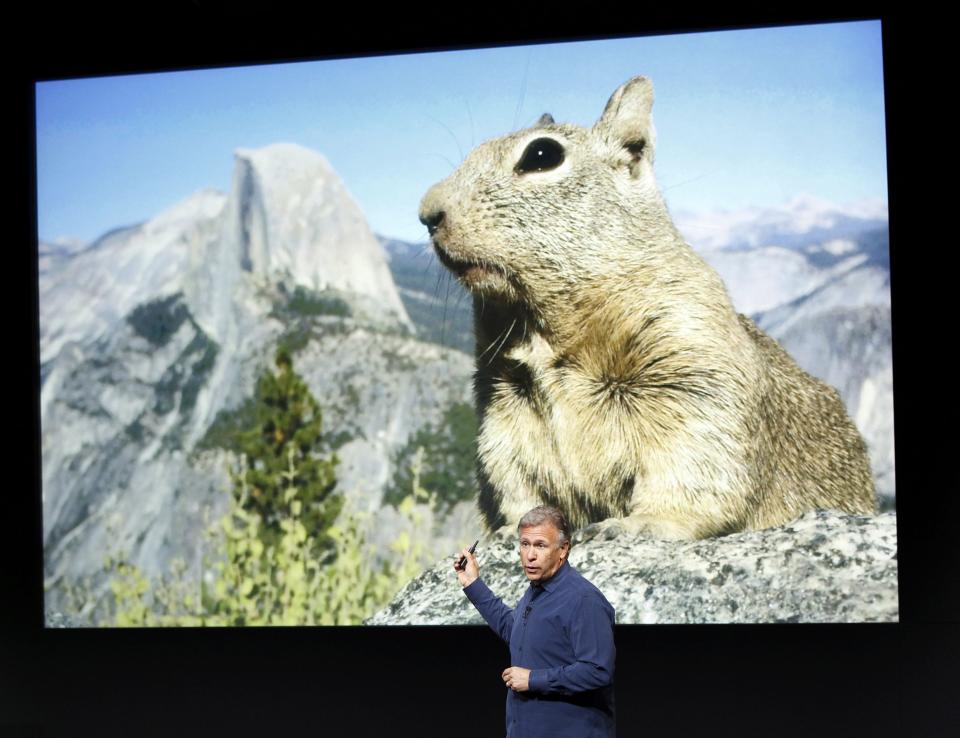 Phil Schiller, senior vice president of worldwide marketing for Apple Inc, talks about the new iPhone 5S camera at Apple Inc's media event in Cupertino, California September 10, 2013. REUTERS/Stephen Lam (UNITED STATES - Tags: BUSINESS SCIENCE TECHNOLOGY BUSINESS TELECOMS)