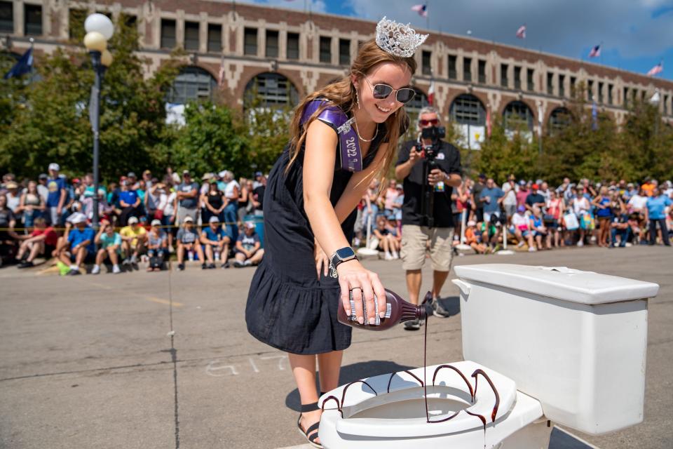 One of 2022 Iowa State Fair Queen Mary Ann Fox's duties included drizzling chocolate sauce on a toilet before the outhouse races.