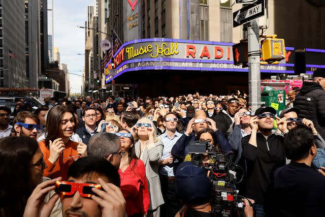 <p>John Lamparski/Getty</p> solar eclipse viewers near Fox News Channel Studios on April 08, 2024 in New York City