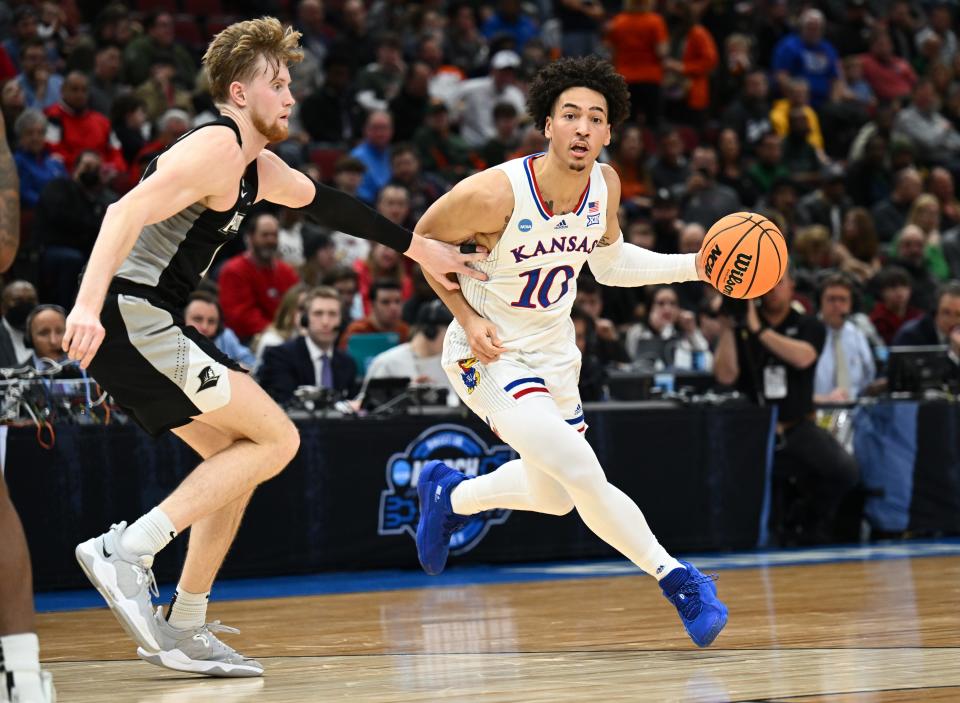 Kansas forward Jalen Wilson (10) dribbles against Providence forward Noah Horchler during the NCAA tournament game March 25 in Chicago. Wilson has been encouraging his younger teammates to aspire for another national title.