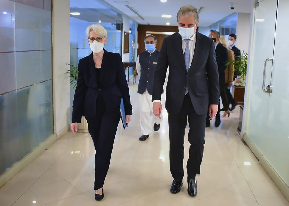 In this photo released by Pakistan's Ministry of Foreign Affairs, visiting U.S. Deputy Secretary of State Wendy Sherman, left, and Pakistan's Foreign Minister Shah Mahmood Qureshi walk towards meeting room at Ministry of Foreign Affairs, in Islamabad, Pakistan, Friday, Oct. 8, 2021. Sherman was meeting senior Pakistani officials Friday amid a worsening relationship between the two countries as each tries to navigate a way forward in Afghanistan under Taliban rule. (Ministry of Foreign Affairs via AP)