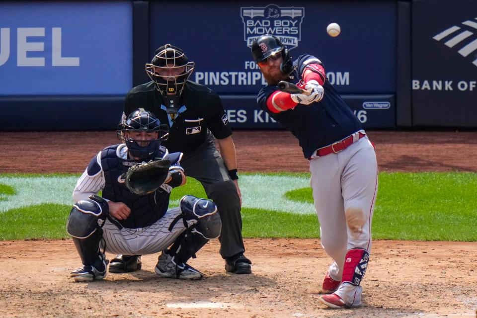 The Boston Red Sox's Justin Turner hits a three-run home run during the seventh inning.