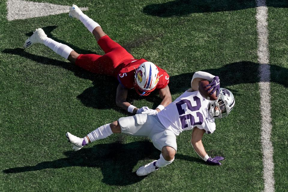 Kansas State running back Deuce Vaughn is tackled by Kansas safety O.J. Burroughs during the second half of a game on Nov. 6, 2021, in Lawrence.