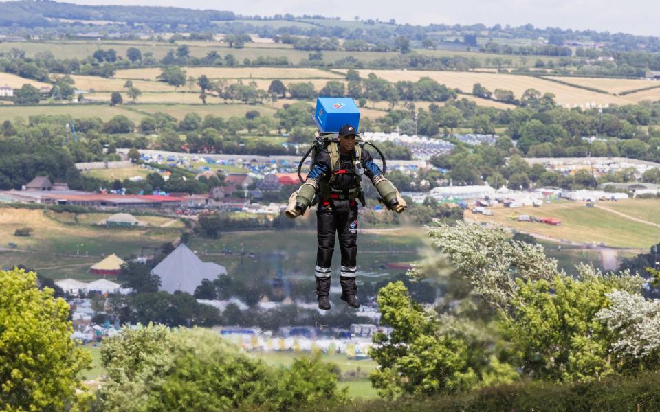 The first ever Domino&#39;s pizza delivery by jetpack at Glastonbury festival earlier today