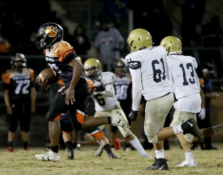 LOS ANGELES, CALIF. - OCT. 22, 2021. Lincoln running back Andre Watkins breaks away for a big touchdown run against Frankin during a game at Lincoln High in Los Angeles on Friday night, Oct. 22, 2021. (Luis Sinco / Los Angeles Times)