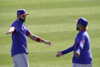 Texas Rangers' Isiah Kiner-Falefa, left, and Willie Calhoun stretch during spring training baseball practice Monday, Feb. 22, 2021, in Surprise, Ariz. (AP Photo/Charlie Riedel)