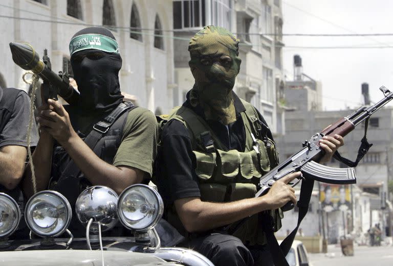 Combatientes palestinos de Hamas marchan en una camioneta con sus armas durante el funeral del extremista Emad Abu Kados, que murió durante enfrentamientos con hombres armados del movimiento Fatah en el vecindario Jeque Radwan, el 13 de junio de 2007, en la Ciudad de Gaza