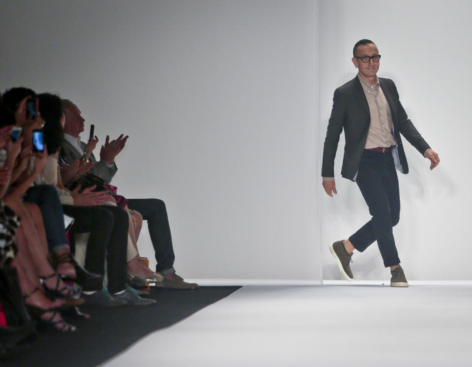 Gilles Mendel appears on the runway after showing his Spring 2014 J. Mendel collection on Wednesday, Sept. 11, 2013 in New York. (AP Photo/Bebeto Matthews)