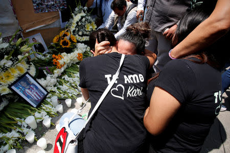 People react for their relative that died in a building that collapsed during the September 2017 earthquake after a minute of silence to honour the victims of the quake in Mexico City, Mexico September 19, 2018. REUTERS/Gustavo Graf