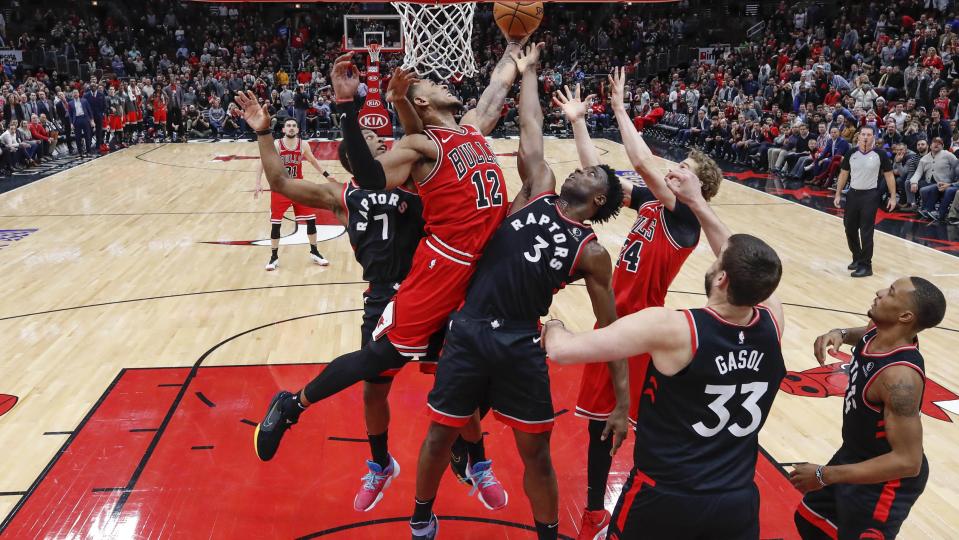 Dec 9, 2019; Chicago, IL, USA; Toronto Raptors guard Kyle Lowry (7), OG Anunoby (3) and center Marc Gasol (33) defend against Chicago Bulls forward Daniel Gafford (12) during the second half at United Center. Mandatory Credit: Kamil Krzaczynski-USA TODAY Sports