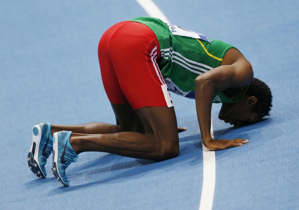 Ethiopia's Mohammed Aman kisses the track after winning the men's 800m final during the Athletics World Indoor Championships in Sopot, Poland, Sunday, March 9, 2014. (AP Photo/Petr David Josek)