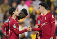 Liverpool's Takumi Minamino, left, celebrates scoring his side's third goal of the game with team-mates during the English League Cup third round soccer match at Carrow Road, Norwich, England, Tuesday Sept. 21, 2021. (Joe Giddens/PA via AP)
