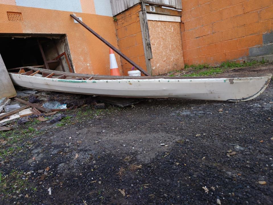 A boat is pictured after being found under a building.