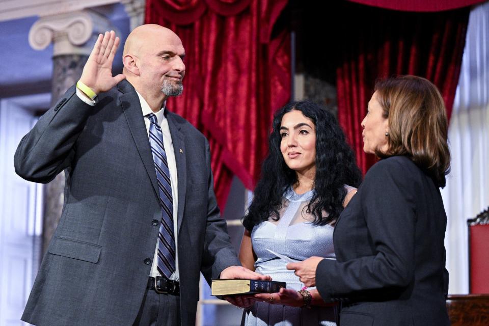 Democratic Sen. John Fetterman of Pennsylvania is ceremonially sworn into office by Vice President Kamala Harris as Fetterman's wife Gisele holds the Bible during a reenactment in the Old Senate Chamber on the first day of the 118th Congress at the US Capitol in Washington, DC, on January 3, 2023.