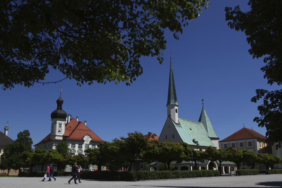 People across the main square 'Kapellplatz" in Altoetting, some 90 kilometers (about 55 miles) east of Munich, Germany, Thursday, May 7, 2020. "The heart of Bavaria and one of the hearts of Europe". Pope emeritus Benedict XVI. said. The city is one of the 'Shrines of Europe', the seven most important Marian pilgrimage sites in Europe. The 'Graminger Weissbraeu' brewery and traditional Bavarian restaurant, which has been in the same family for a century, is preparing to welcome guests back to its restaurant for the first time in two months — with new rules and fears for the future. (AP Photo/Matthias Schrader)