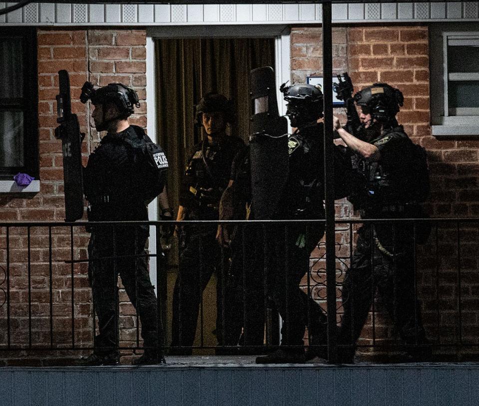 Heavily armed police stand on the second floor of the Days Inn Motel in Elmsford April 14, 2024 where a man was barricaded in a room. The situation began at around 4:00 pm and ended after 9:00 pm.