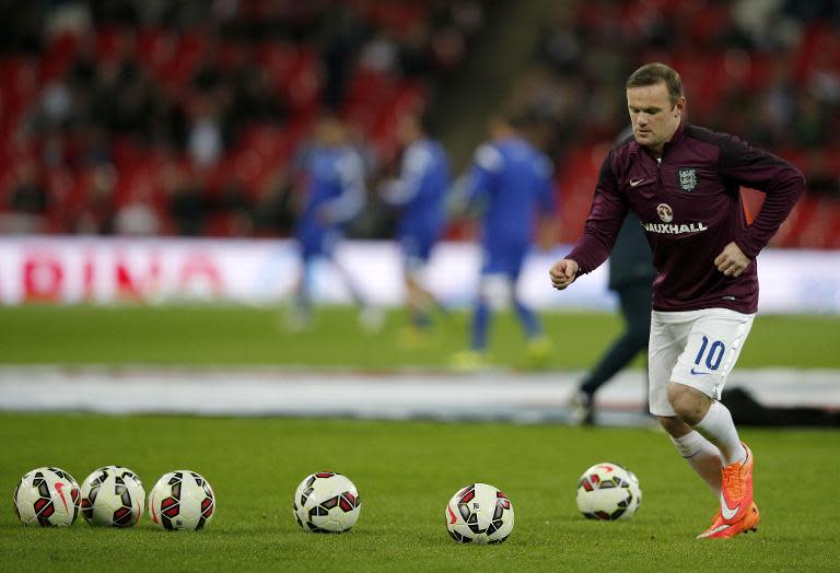 England's forward Wayne Rooney warms up before a Euro 2016 Qualifier football match between England and San Marino at Wembley Stadium in north London, on October 9, 2014