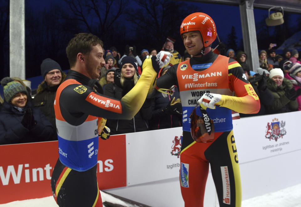 Toni Eggert and Sascha Benecken of Germany celebrate after finishing first in a men's doubles race at the Luge World Cup event in Sigulda, Latvia, Saturday, Jan. 12, 2019. (AP Photo/Roman Koksarov)