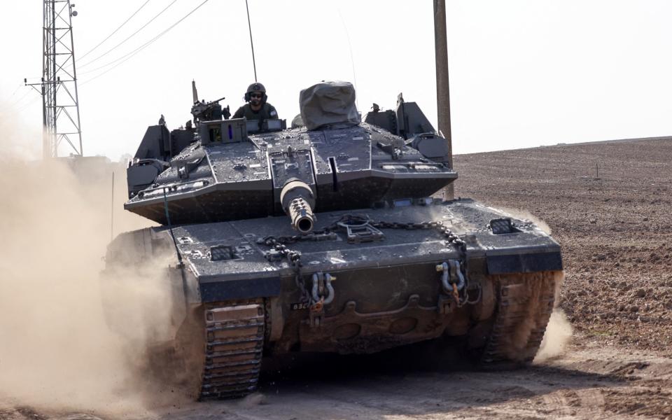 An Israeli tank rolls near the border with Gaza