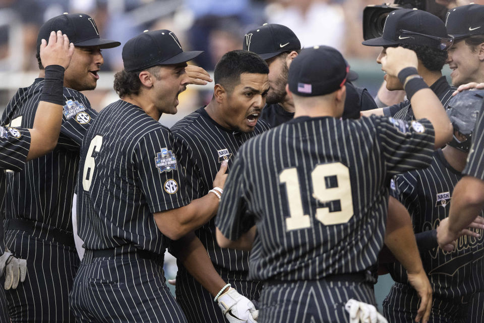 Vanderbilt's Jayson Gonzalez, center, celebrates with teammates as he returns to the dugout after hitting a two-run home run against Arizona in the fifth inning during a baseball game in the College World Series, Saturday, June 19, 2021, at TD Ameritrade Park in Omaha, Neb. (AP Photo/Rebecca S. Gratz)