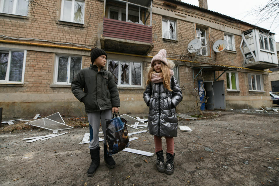 <p>DONETSK, UKRAINE - FEBRUARY 24: Children are seen as people clean and try to fix damaged houses after attacks in Yasinovataya (Yasynuvata) controlled by the pro-Russian separatists, self-proclaimed so-called Donetsk People's Republic (DNR), Ukraine on February 24, 2022. (Photo by Stringer/Anadolu Agency via Getty Images)</p> 
