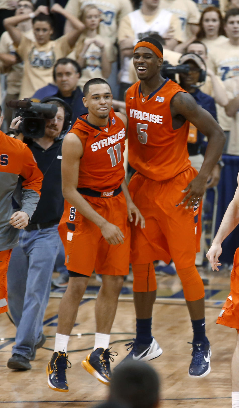 Syracuse's Tyler Ennis (11) celebrates with C.J. Fair (5) after hitting a 3-point shot with less than a second remaining in an NCAA college basketball game against Pittsburgh on Wednesday, Feb. 12, 2014, in Pittsburgh. Syracuse won 58-56. (AP Photo/Keith Srakocic)