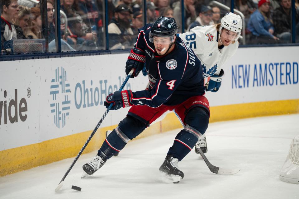 Dec 23, 2023; Columbus, Ohio, USA;
Columbus Blue Jackets center Cole Sillinger (4) grabs the loose puck against Toronto Maple Leafs defenseman William Lagesson (85) during the third period of their game on Saturday, Dec. 23, 2023 at Nationwide Arena.