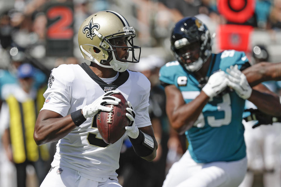 New Orleans Saints quarterback Teddy Bridgewater, left, looks for a receiver as he is pressured by Jacksonville Jaguars defensive end Calais Campbell during the first half of an NFL football game, Sunday, Oct. 13, 2019, in Jacksonville, Fla. (AP Photo/John Raoux)