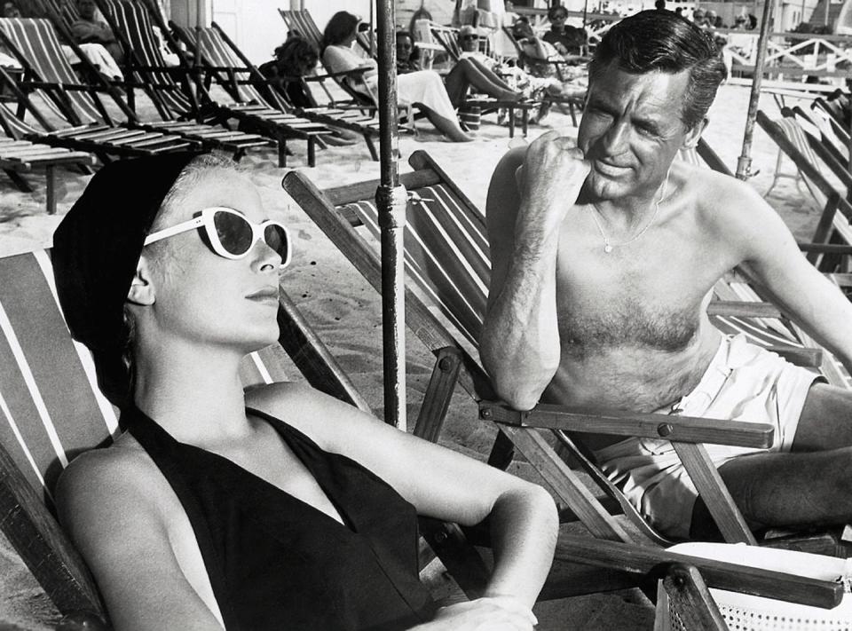 <p>In 1955, Grant returned to the big screen in a major way, starring with Grace Kelly in the Alfred Hitchcock film <em>To Catch a Thief</em>. Here, he films a scene on the beach with the actress.</p>