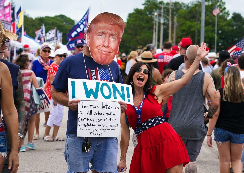 Wearing a cutout of Donald Trump’s face, Marc DiMaggio of Punta Gorda has his photo taken with Lisa Rudolph during a rally for former President Donald Trump at the Sarasota Fairgrounds on July 3, 2021.