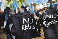 Demonstrators take part in a protest during the visit of Chinese Foreign Minister Wang Yi in Berlin, Germany, Tuesday, Sept. 1, 2020. German Foreign Minister Heiko Maas meets his Chinese counterpart at the foreign ministry guest house Villa Borsig for bilateral talks. (AP Photo/Markus Schreiber)