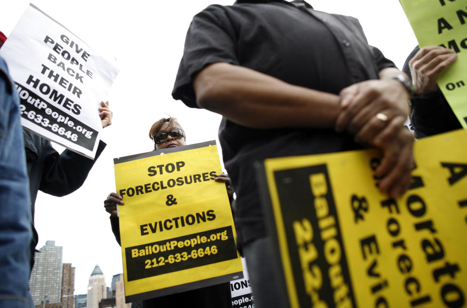 People protest outside the entrance for the Real Estate Disposition Corp (REDC) Foreclosure Home Auction in New York, March 8, 2009. The auction of foreclosed homes in New York City on Sunday drew protesters who blamed banks for an epidemic of home losses and called for a moratorium on evictions and foreclosures.  REUTERS/Shannon Stapleton   (UNITED STATES BUSINESS CONFLICT IMAGE OF THE DAY TOP PICTURE)